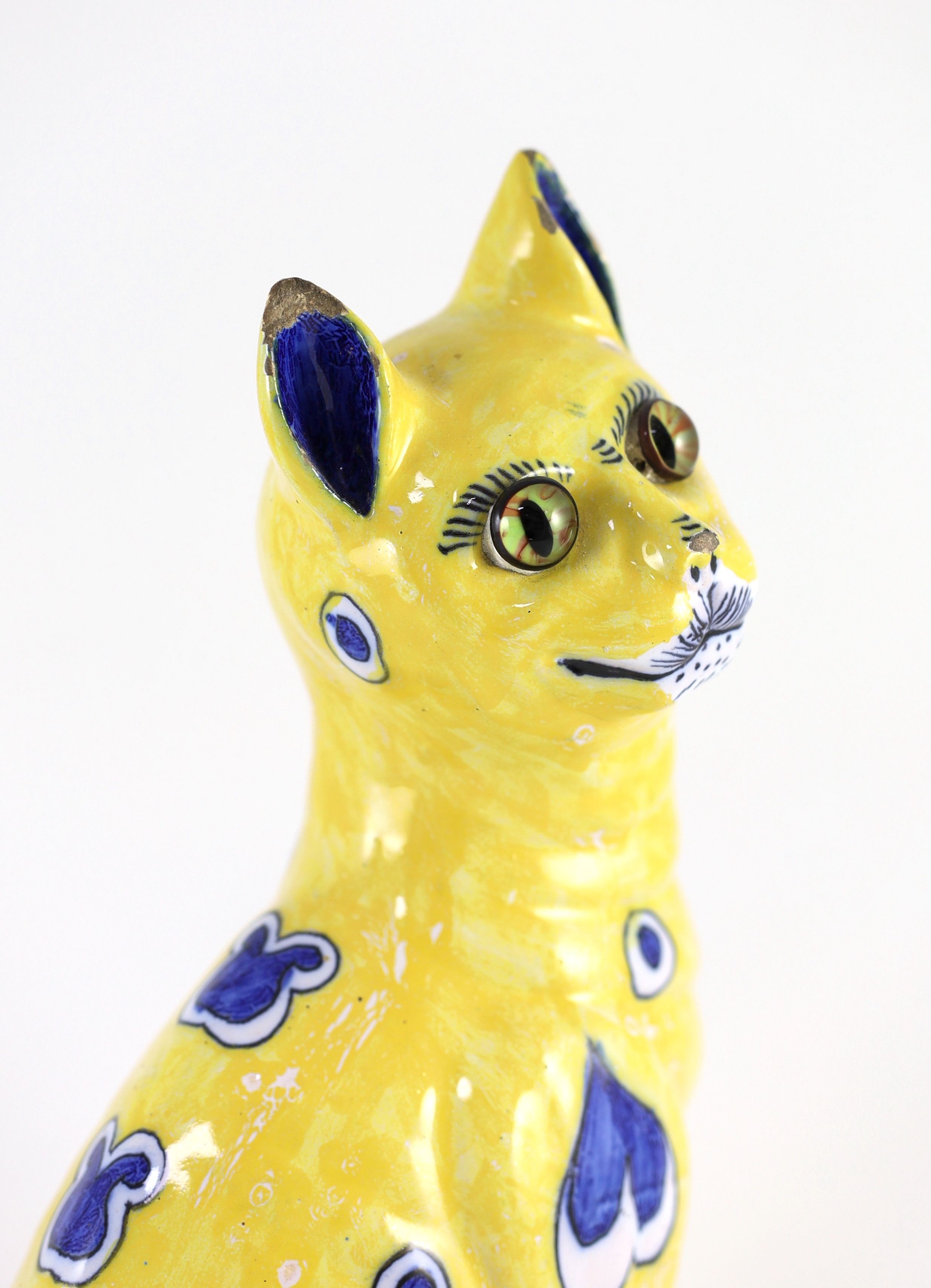 A Gallé yellow faience model of a seated smiling cat, c.1885, 33cm high, small faults